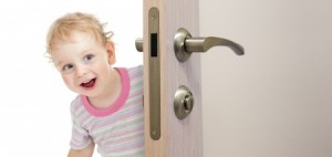Child peering round a door
